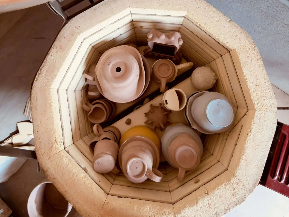 Top-down view of a loaded kiln full of bisque pottery at Annebrije Pottery Studio in Brownsville, TX
